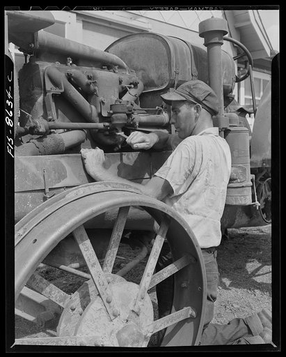 Untitled photo, possibly related to: Beltsville, Maryland. Employees of the United States Department of Agriculture experimental farm demonstrating the care and repair of farm machinery for posters to be used in a "Share and Repair" conservation program