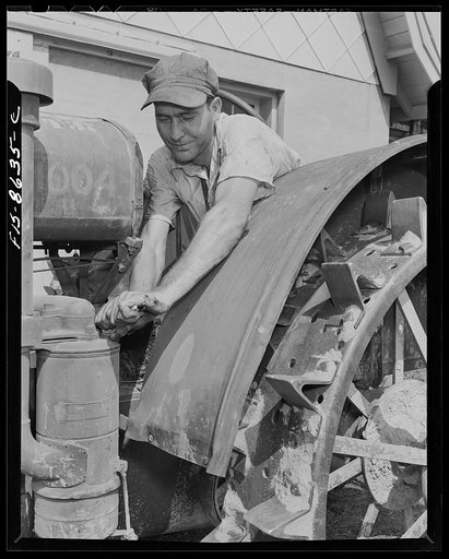 Beltsville, Maryland. Employees of the United States Department of Agriculture experimental farm demonstrating the care and repair of farm machinery for posters to be used in a "Share and Repair" conservation program