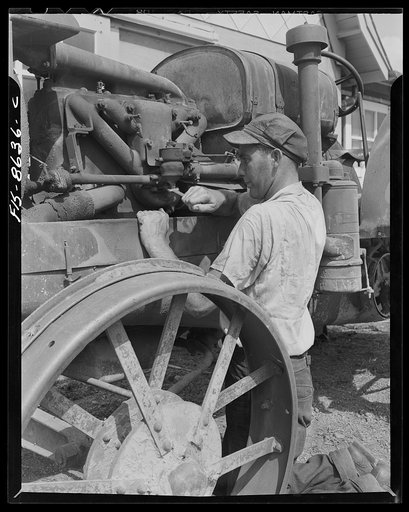 Untitled photo, possibly related to: Beltsville, Maryland. Employees of the United States Department of Agriculture experimental farm demonstrating the care and repair of farm machinery for posters to be used in a "Share and Repair" conservation program