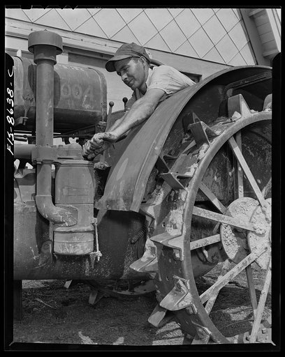 Beltsville, Maryland. Employees of the United States Department of Agriculture experimental farm demonstrating the care and repair of farm machinery for posters to be used in a "Share and Repair" conservation program
