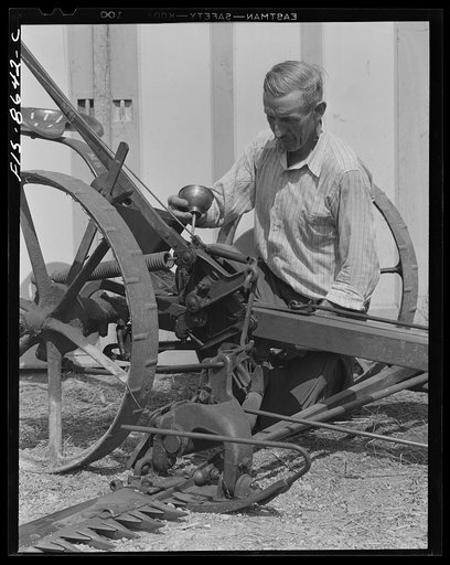 Beltsville, Maryland. Employees of the United States Department of Agriculture experimental farm demonstrating the care and repair of farm machinery for posters to be used in a "Share and Repair" conservation program