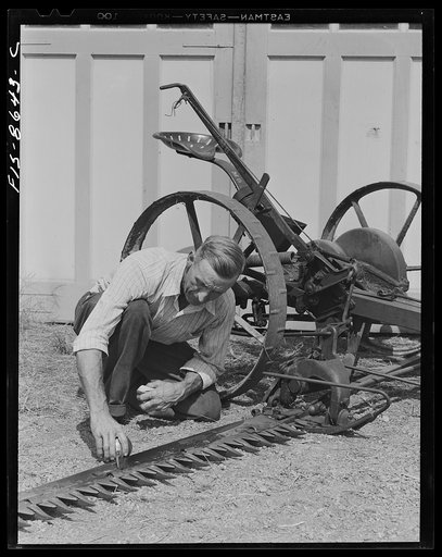Beltsville, Maryland. Employees of the United States Department of Agriculture experimental farm demonstrating the care and repair of farm machinery for posters to be used in a "Share and Repair" conservation program