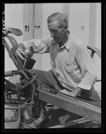 Beltsville, Maryland. Employees of the United States Department of Agriculture experimental farm demonstrating the care and repair of farm machinery for posters to be used in a "Share and Repair" conservation program