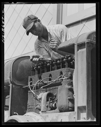 Beltsville, Maryland. Employees of the United States Department of Agriculture experimental farm demonstrating the care and repair of farm machinery for posters to be used in a "Share and Repair" conservation program