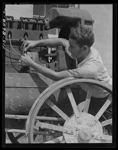 Beltsville, Maryland. Employees of the United States Department of Agriculture experimental farm demonstrating the care and repair of farm machinery for posters to be used in a "Share and Repair" conservation program