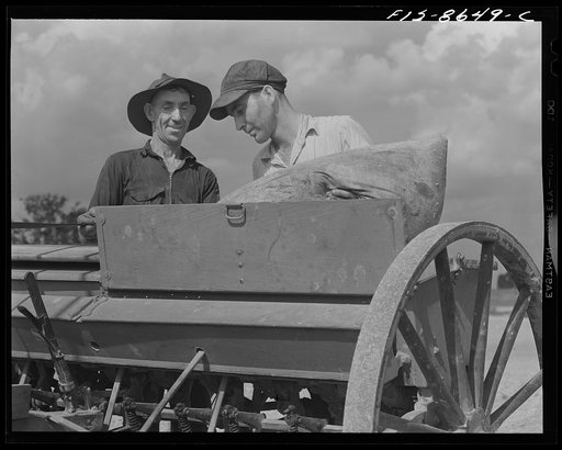 Beltsville, Maryland. Employees of the United States Department of Agriculture experimental farm demonstrating the care and repair of farm machinery for posters to be used in a "Share and Repair" conservation program