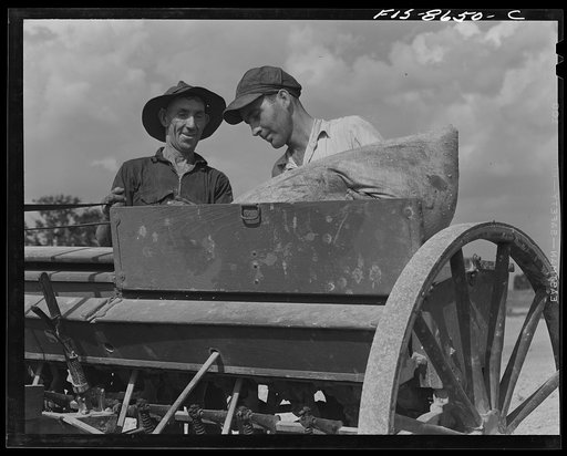 Untitled photo, possibly related to: Beltsville, Maryland. Employees of the United States Department of Agriculture experimental farm demonstrating the care and repair of farm machinery for posters to be used in a "Share and Repair" conservation program