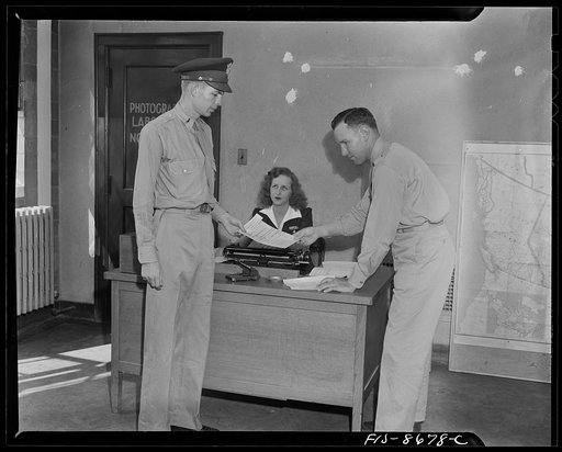 Wayne County Airport, a United States Army Air Corps air ferry command base sixteen miles from Detroit, Michigan. Lieutenant Benton receiving his flight orders