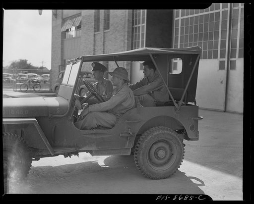 Wayne County Airport, a United States Army Air Corps air ferry command base sixteen miles from Detroit, Michigan. Lieutenant Benton riding onto the field in a jeep