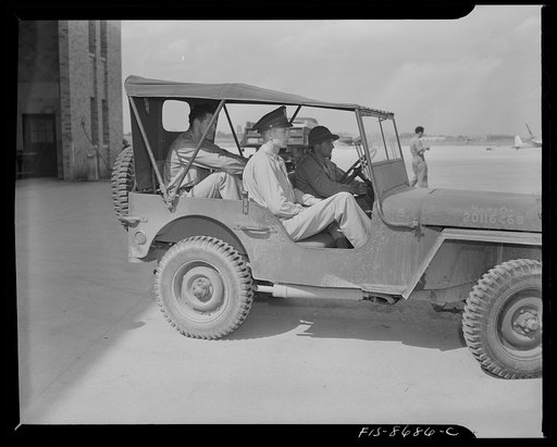 Wayne County Airport, a United States Army Air Corps air ferry command base sixteen miles from Detroit, Michigan. Lieutenant Benton riding onto the field in a jeep