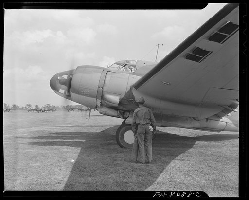 Wayne County Airport, a United States Army Air Corps air ferry command base sixteen miles from Detroit, Michigan. Lieutenant Benton starting the motor with the supercharger