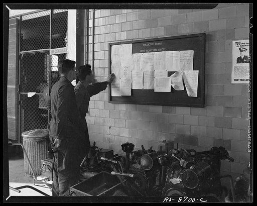 Wayne County Airport, a United States Army Air Corps air ferry command base sixteen miles from Detroit, Michigan. Mechanics repairing a mudguard on a wheel