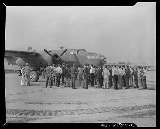 Wayne County Airport, a United States Army Air Corps air ferry command base sixteen miles from Detroit, Michigan. Factory men inspecting the ship