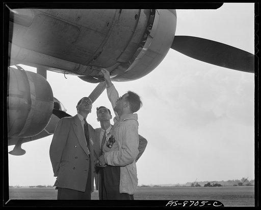 Wayne County Airport, a United States Army Air Corps air ferry command base sixteen miles from Detroit, Michigan. Factory men inspecting the ship
