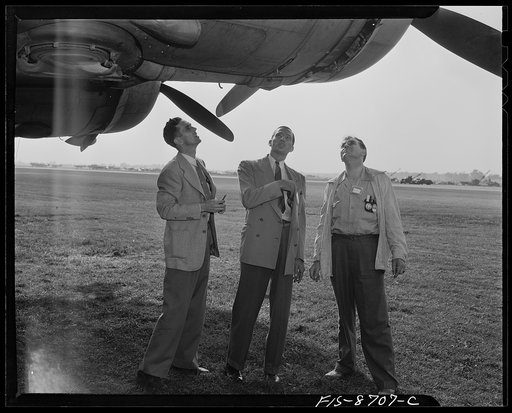 Wayne County Airport, a United States Army Air Corps air ferry command base sixteen miles from Detroit, Michigan. Factory men inspecting the ship