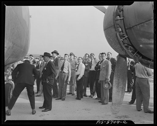 Wayne County Airport, a United States Army Air Corps air ferry command base sixteen miles from Detroit, Michigan. Factory men inspecting the ship