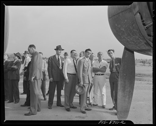 Wayne County Airport, a United States Army Air Corps air ferry command base sixteen miles from Detroit, Michigan. Factory men inspecting the ship