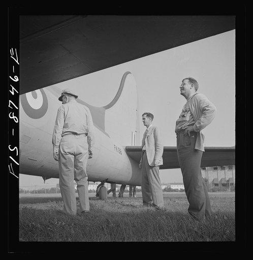 Wayne County Airport, a United States Army Air Corps air ferry command base sixteen miles from Detroit, Michigan. Workers inspecting a plane