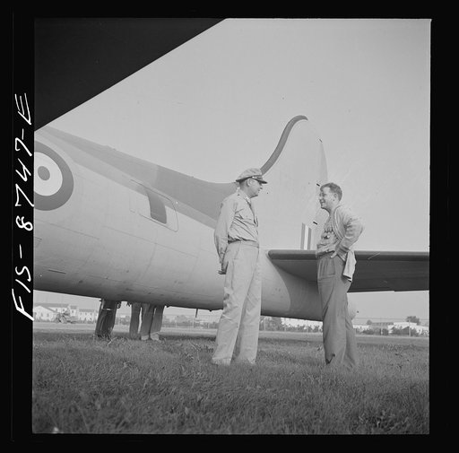 Untitled photo, possibly related to: Wayne County Airport, a United States Army Air Corps air ferry command base sixteen miles from Detroit, Michigan. Workers inspecting a plane