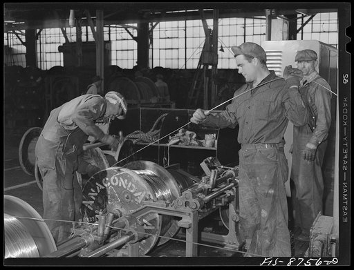 Great Falls, Montana. Anaconda Wire and Cable Company. Removing a full spool of copper wire from a drawing machine