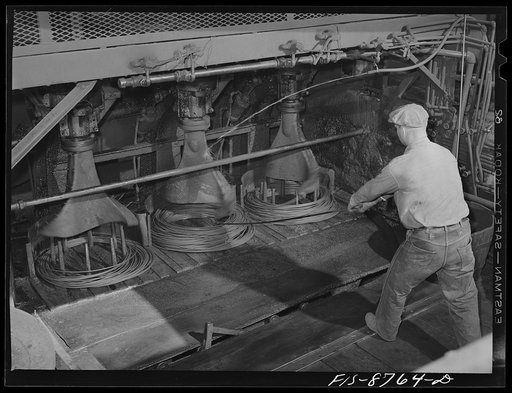 Untitled photo, possibly related to: Great Falls, Montana. Anaconda Wire and Cable Company. After copper wire is drawn through various dies to the desired size, it is formed into coils by a fishtail winder