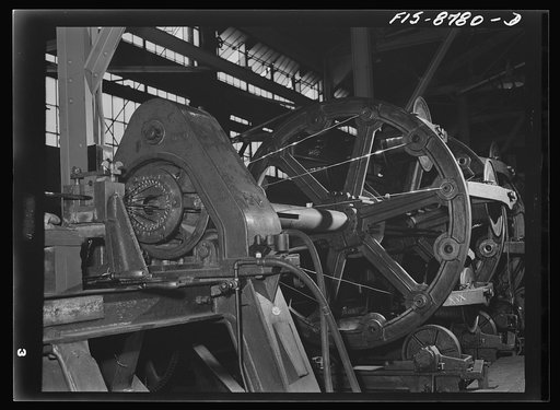 Great Falls, Montana. Anaconda Wire and Cable Company. Stranding machine for making copper cable; in this machine the copper wire is located in bobbins in the frame; as this frame revolves the wires are laid on a wire core, thus forming the stranded cable; stranded cable may be solid or hollow depen