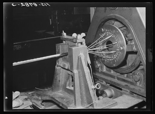 Great Falls, Montana. Anaconda Wire and Cable Company. Stranding hollow conductor cable; the several wires in the frame revolve and are laid upon the spiral core, thus forming the hollow conductor cable