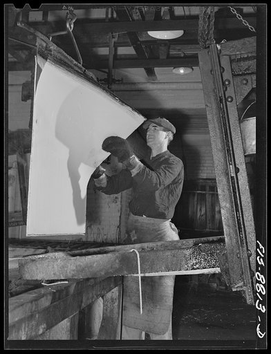 Great Falls, Montana. Electolytic copper refinery of Anaconda Copper Mining Company. Preparing starting sheets; the workman is shown stripping the starting sheet of electolytic copper; this copper has been deposited on a rolled copper blank, which has been lightly greased so as to prevent the deposi