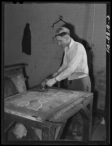 Great Falls, Montana. Electrolytic copper refinery of Anaconda Copper Mining Company. Smoothing a copper blank before it is lightly greased; this copper blank will then be placed in an electrolytic tank; a deposit of copper will form which will make the starting sheet which will then be stripped fro