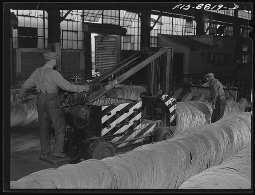 Great Falls, Montana, Anaconda Wire and Cable Company. Wire rods are stacked in warehouse by this machine which can stack several tons at once