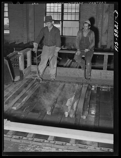 Great Falls, Montana. Furnace refinery of Anaconda Copper Mining Company. The cast wire bars proceed on a conveyor where they are inspected several times while cooling