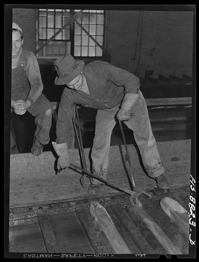 Great Falls, Montana. Furnace refinery of Anaconda Copper Mining Company. The cast wire bars proceed on a conveyor where they are inspected several times while cooling