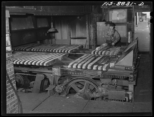 Great Falls, Montana. Anaconda Wire and Cable Company. Wire bars are placed on a conveyor which pushes them gradually into the heating furnace where they are brought up to correct temperature for rolling into rods