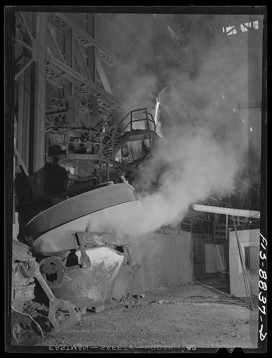 Anaconda smelter, Montana. Anaconda Copper Mining Company. In the lower left hand corner, copper from the reverberatory furnace is being poured onto a ladle from which it will be carried to the converter in the upper background; first pourings of slag from the converter are being poured back into th