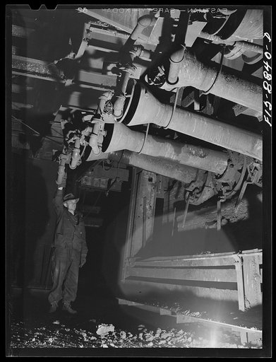 Anaconda smelter, Montana. Anaconda Copper Mining Company. Workman adjust the gas which is the fuel for the reverberatory furnace