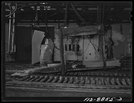 Untitled photo, possibly related to: Great Falls, Montana. Electrolytic copper refinery of Anaconda Copper Mining Company. Preparing starting sheets; the workman is shown stripping the starting sheet of electrolytic copper; this copper has been deposited on a rolled copper blank, which has been ligh