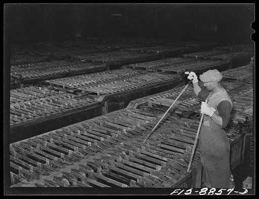 Great Falls, Montana. Electolytic copper refinery of Anaconda Copper Mining Company. Inspecting the electrolytic process; by means of this tool which is thrust down and towards the inspector he is able to determine if deposition of copper is proceeding at the normal rage and if there are any short c