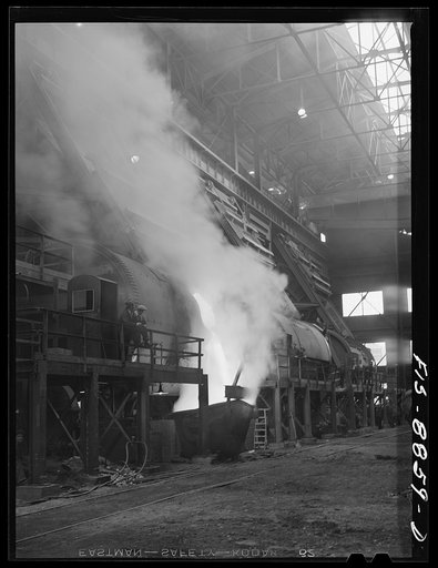 Anaconda smelter, Montana. Anaconda Copper Mining Company. Battery of converters; in near converter, copper is being poured into ladle. In the converter, impurities in the copper are removed by oxidation with air and the final product approximates 99.3% pure copper