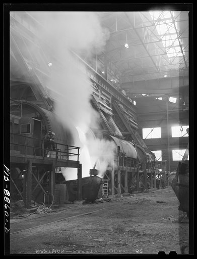 Untitled photo, possibly related to: Anaconda smelter, Montana. Anaconda Copper Mining Company. Battery of converters; in near converter, copper is being poured into ladle. In the converter, impurities in the copper are removed by oxidation with air and the final product approximates 99.3% pure copp