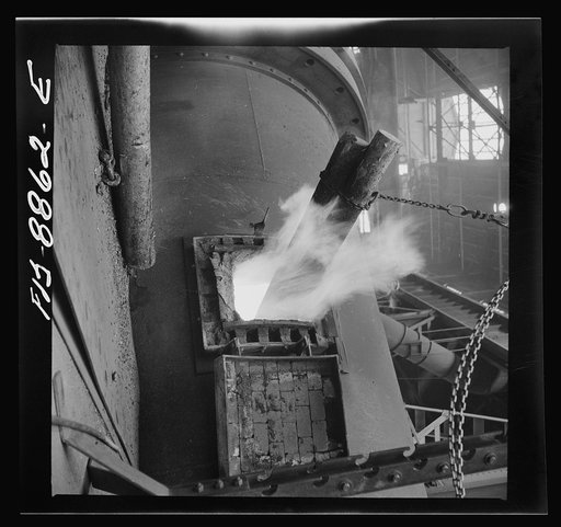 Anaconda smelter, Montana. Anaconda Copper Mining Company. Poling in the refining furnace. Wooden pole are plunged into the molten copper; there is a great evolution of gases when this is done and the excess oxygen combines with the carbon of the the wood and passes off as carbon monoxide. This refi