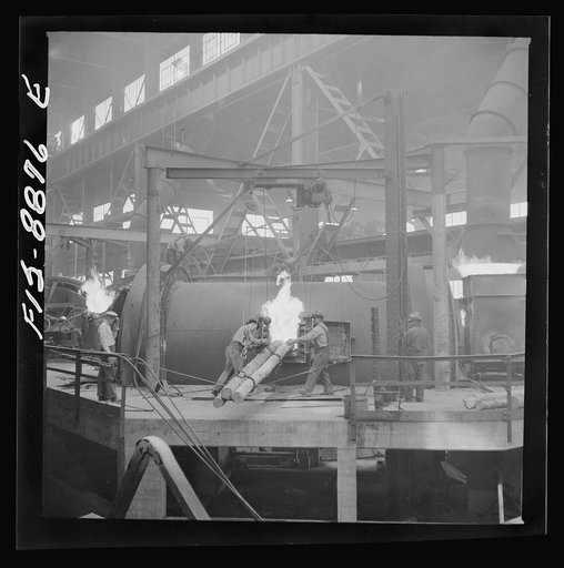 Anaconda smelter, Montana. Anaconda Copper Mining Company. Poling in the refining furnace. Wooden poles are plunged into the molten copper; there is a great evolution of gases when this is done and the excess oxygen combines with the carbon of the wood and passes off as carbon monixide. This refinin