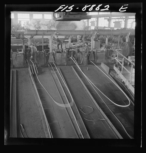 Untitled photo, possibly related to: Great Falls, Montana. Anaconda Wire and Cable Company. The finishing mill where copper wire bars are reduced to copper rods by running through a series of rolls. From this mill the rods are coiled and are then treated with a dilute solution of sulphuric acid and 