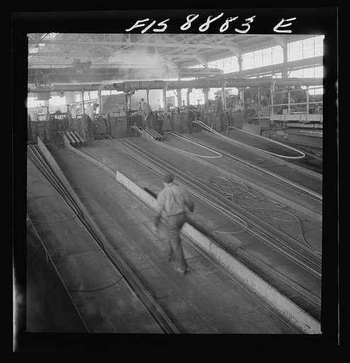 Untitled photo, possibly related to: Great Falls, Montana. Anaconda Wire and Cable Company. The finishing mill where copper wire bars are reduced to copper rods by running through a series of rolls. From this mill the rods are coiled and are then treated with a dilute solution of sulphuric acid and 