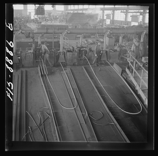 Great Falls, Montana. Anaconda Wire and Cable Company. The finishing mill where copper wire bars are reduced to copper rods by running them through a series of rolls. From this mill the rods are coiled and are then treated with a dilute solution of sulphuric acid and washed with water after which th
