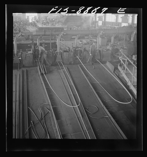 Untitled photo, possibly related to: Great Falls, Montana. Anaconda Wire and Cable Company. The finishing mill where copper wire bars are reduced to copper rods by running through a series of rolls. From this mill the rods are coiled and are then treated with a dilute solution of sulphuric acid and 