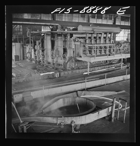 Great Falls, Montana. Anaconda Wire and Cable Company. Billet heating furnace and intermediate rolls where the copper wire bar, which is the blunt white bar in left center, is converted to the rod at its immediate right and further reduced to size of that shown in right foreground