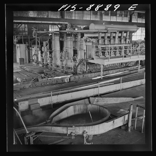 Anaconda smelter, Montana. Anaconda Copper Mining Company. Copper converter in action. Object of converting is to eliminate sulphur and iron; this is accomplished by blowing compressed air through the molten charge. The oxidation products unite with silica which is added to form a slag which floats 