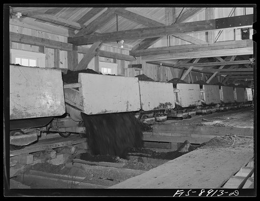 Ben Bow chromite mine, Stillwater County, Montana. Self-dumping ore cars discharge their contents into a large hopper; this chrome ore is then transferred to the mill by an aerial tram