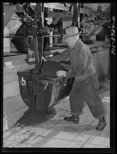 Ben Bow chromite mine, Stillwater County, Montana. Loading a bucket with chrome ore before transporting by an aerial tram from the mine to the mill