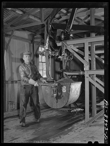 Untitled photo, possibly related to: Ben Bow chromite mill, Stillwater County, Montana. Buckets full of chrome ore are guided to the storage bins at the mill
